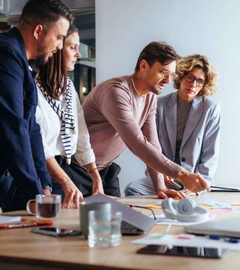 Ein Webagentur Team bespricht sich gerade an einem Tisch.